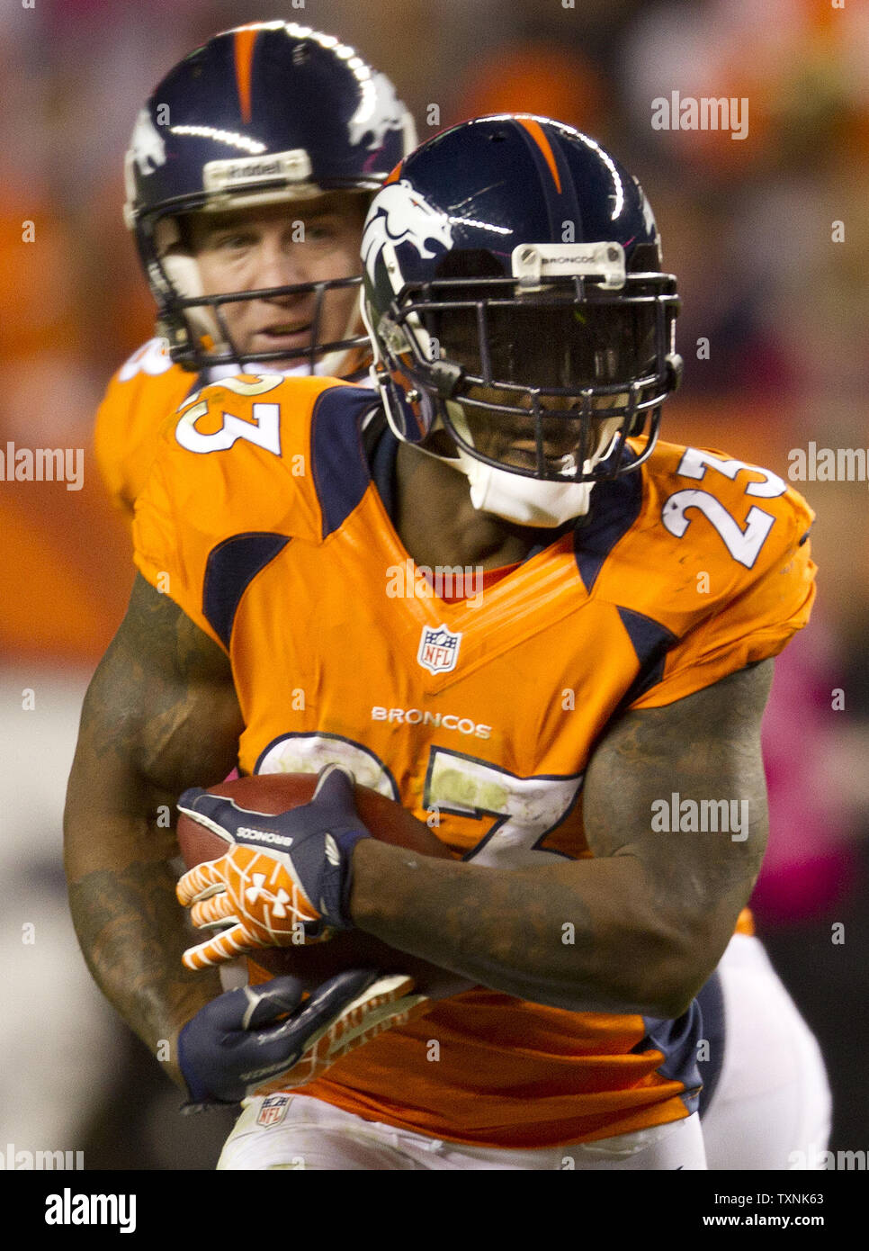 Denver Broncos running back Willis McGahee (L) scores against Buffalo Bills  linebacker Reggie Torbor on a 13-yard touchdown pass in the second quarter  at Sports Authority Field at Mile High in Denver