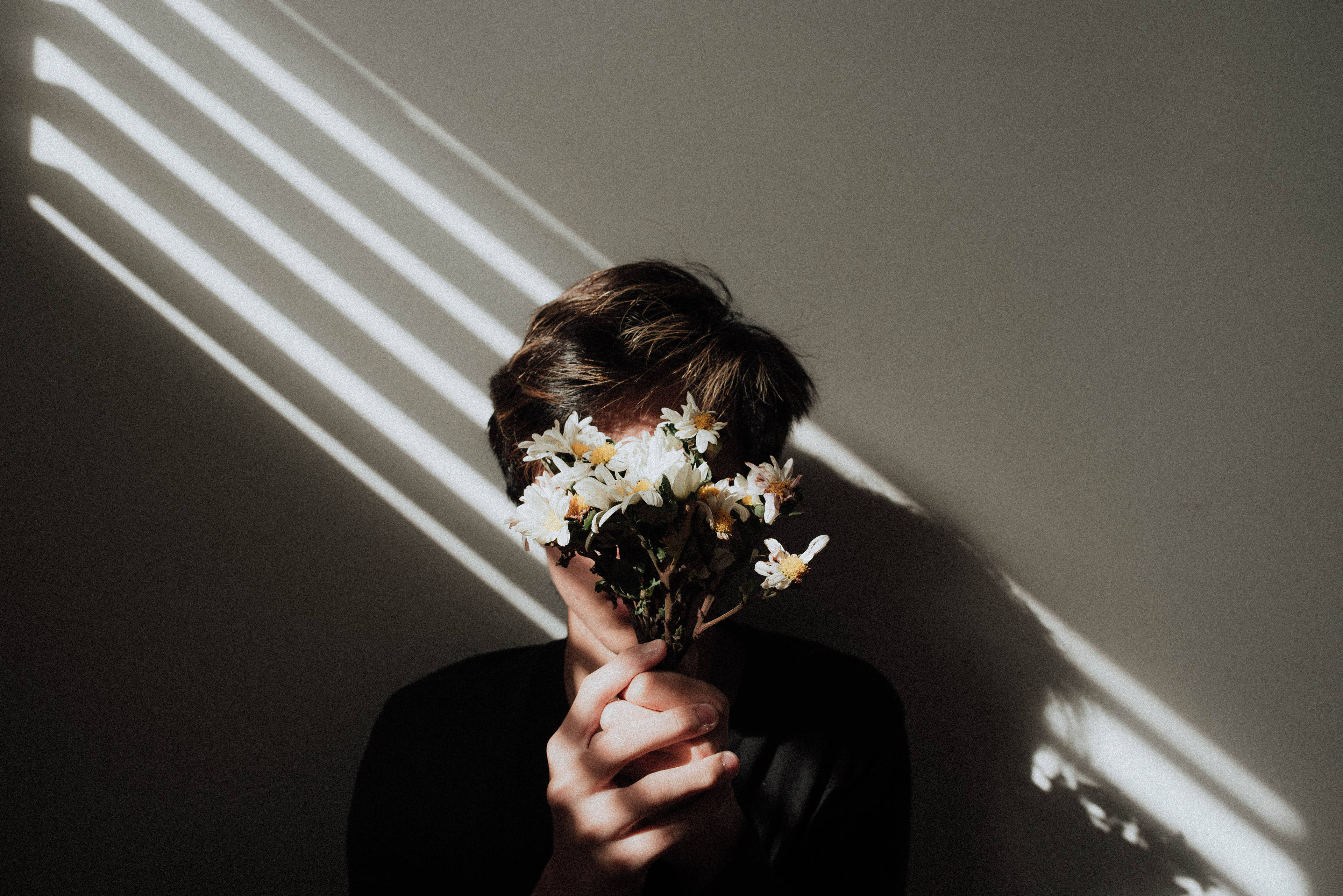 Download man holding flowers aesthetic wallpaper