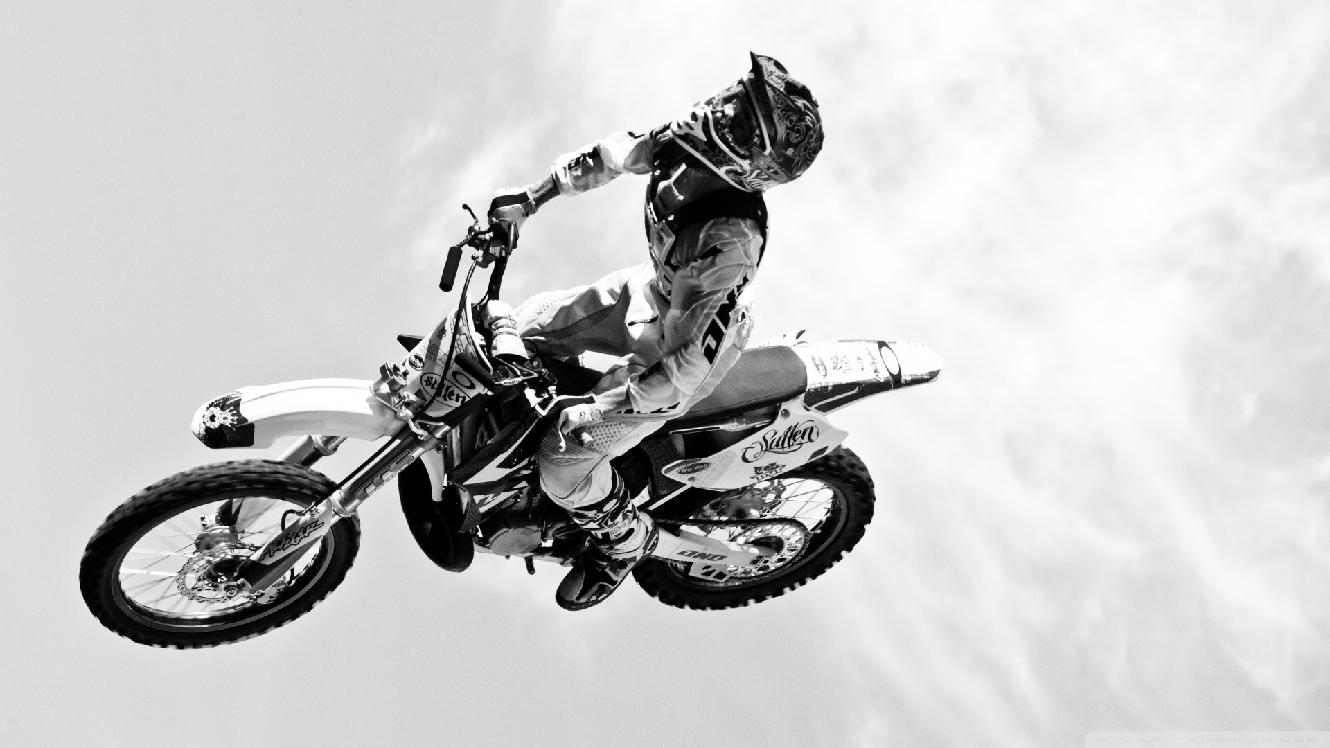 Dirtbike moto vehicles motorcycle motorbike bike flight fly black white wheels people uniform sky clouds extreme sports racing cross wallpaper x