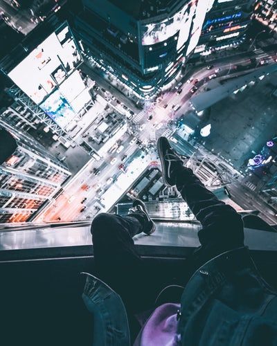 Person sitting on top of the building during nighttime night landscape night city sitting on rooftop aesthetic night