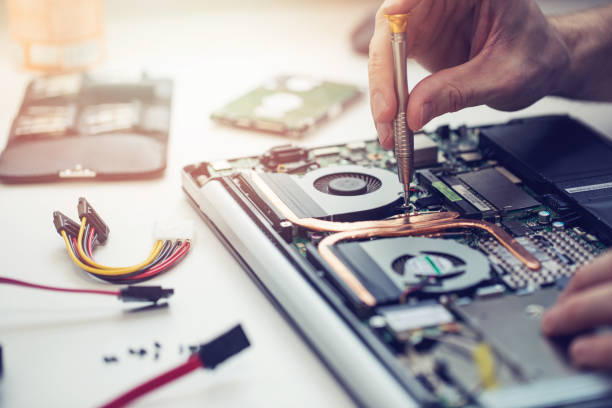 Technician repairing laptop puter closeup stock photo