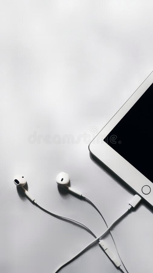 White earphones with ipad and headphones wallpapers in white background wallpaper photos stock image