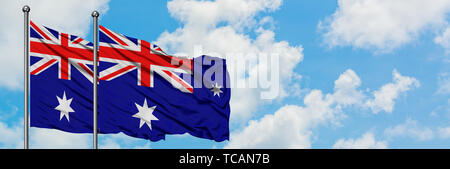 Australia and heard island and mcdonald islands flag waving in the wind against white cloudy blue sky together diplomacy concept international relat stock photo