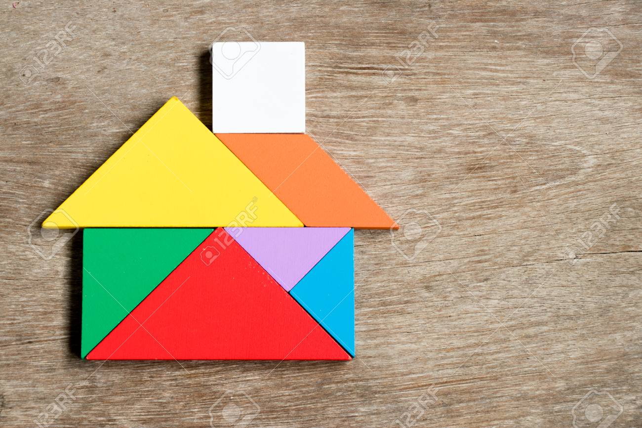 Color tangram puzzle in house shape on wood background stock photo picture and royalty free image image