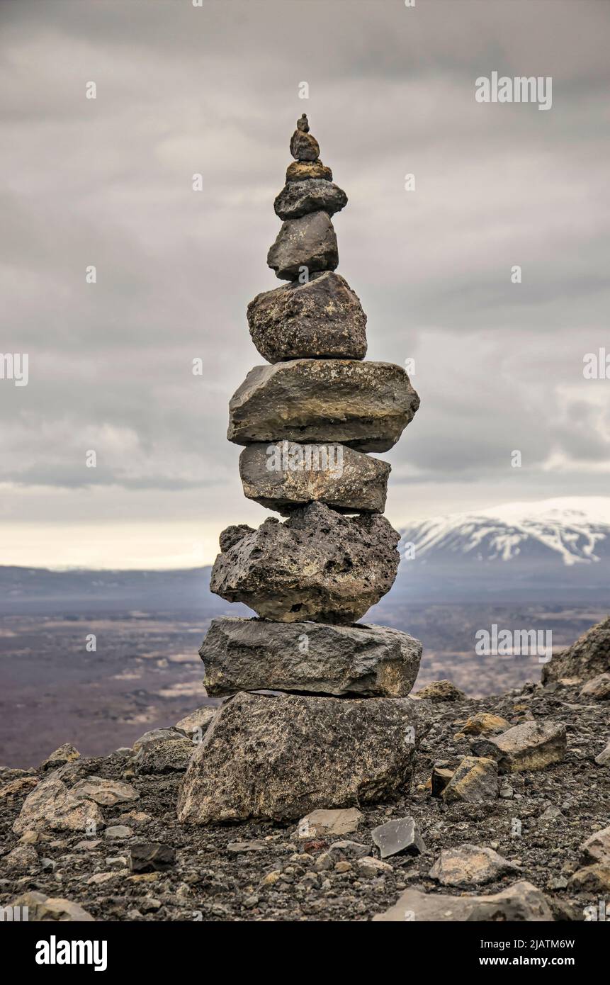 Man stacking stones hi