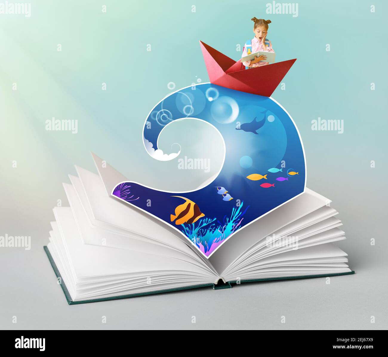 Open book with drawn sea wave and surprised little schoolgirl in paper boat on color background stock photo