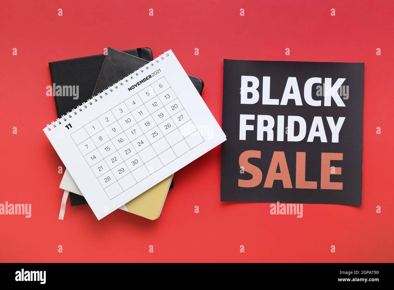 Calendar page of november and notebooks on color background black friday stock photo