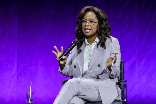 Oprah winfrey pops in lavender for the color purple at cinemacon â footwear news