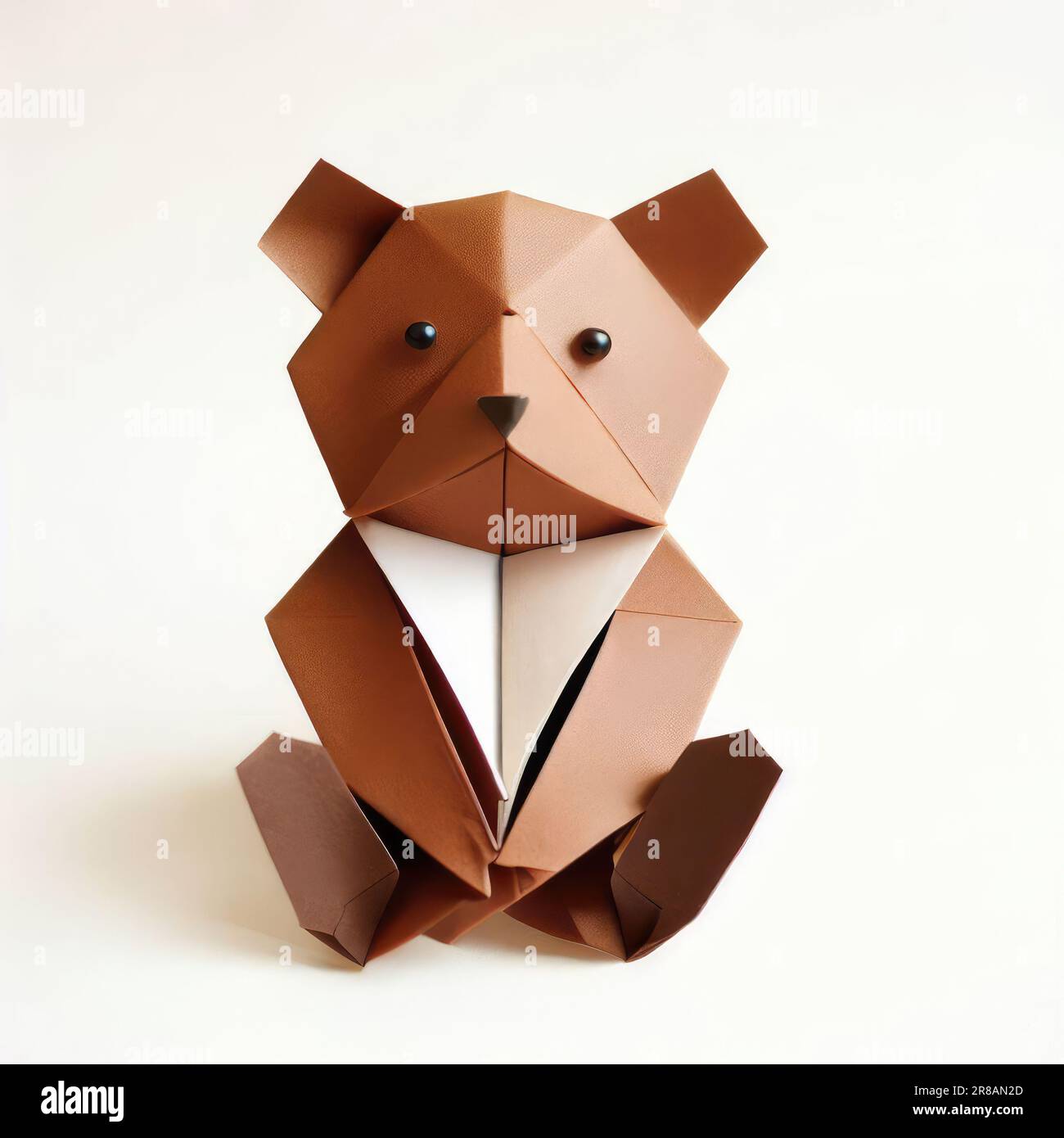 Folded seated origami teddy bear paper art stock photo