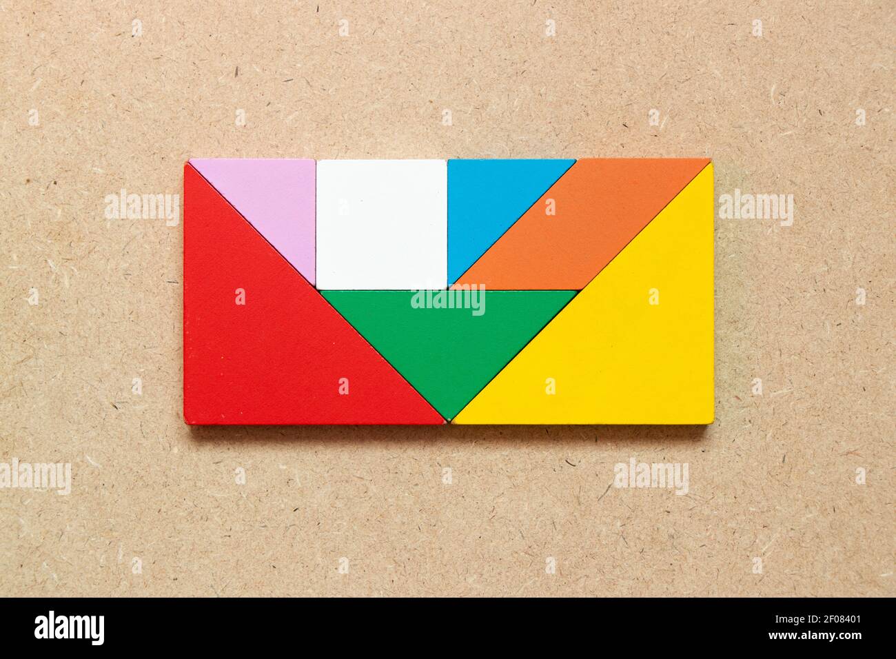 Color tangram puzzle in rectangle shape on wood background stock photo