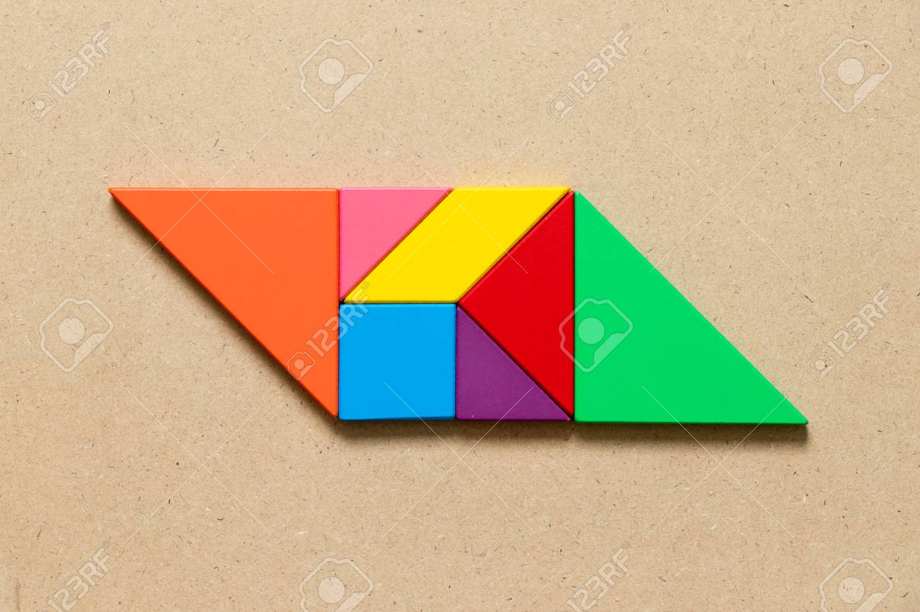 Color tangram puzzle in parallelogram shape on wood background stock photo picture and royalty free image image