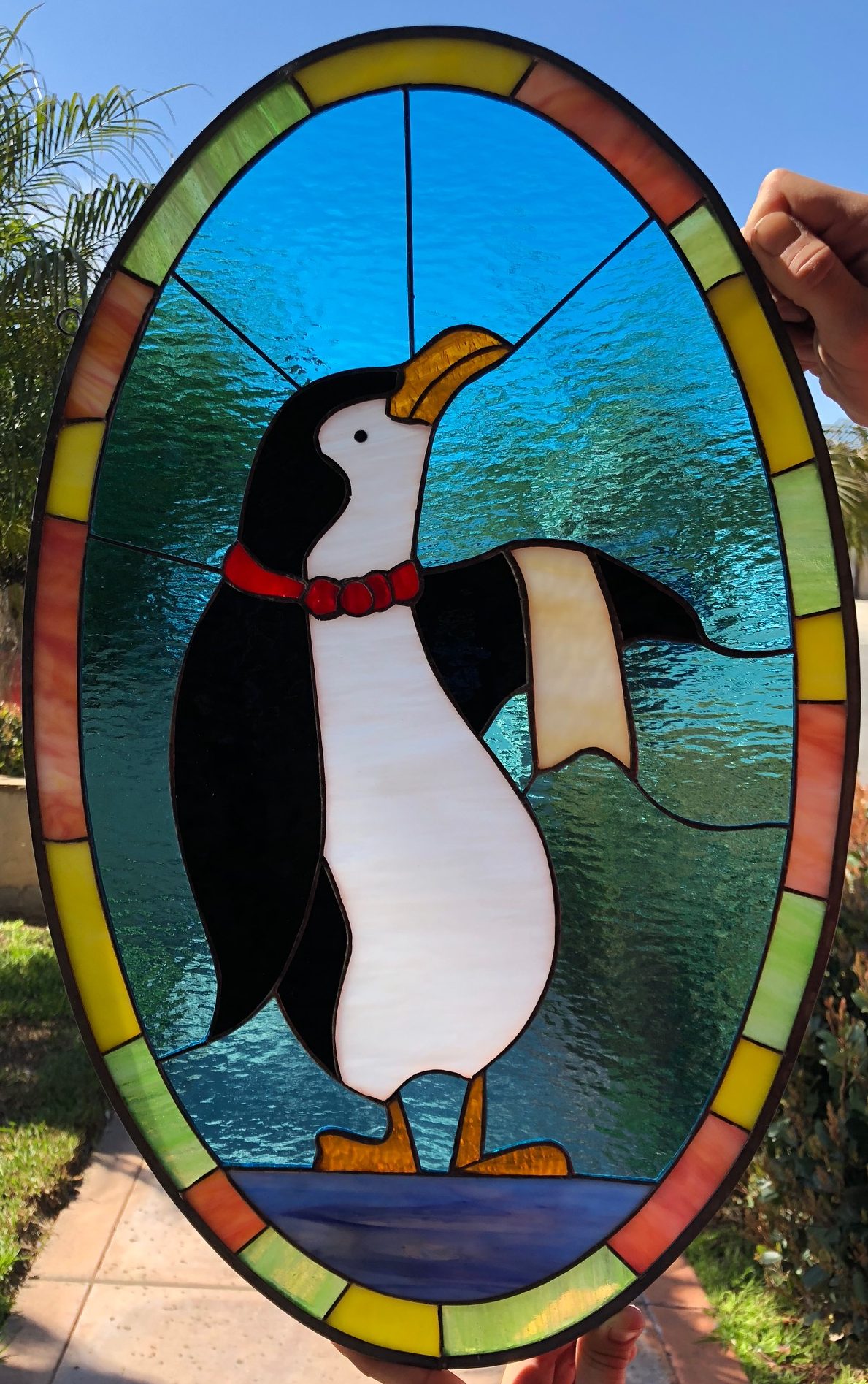 The penguin waiter stained glass window panel