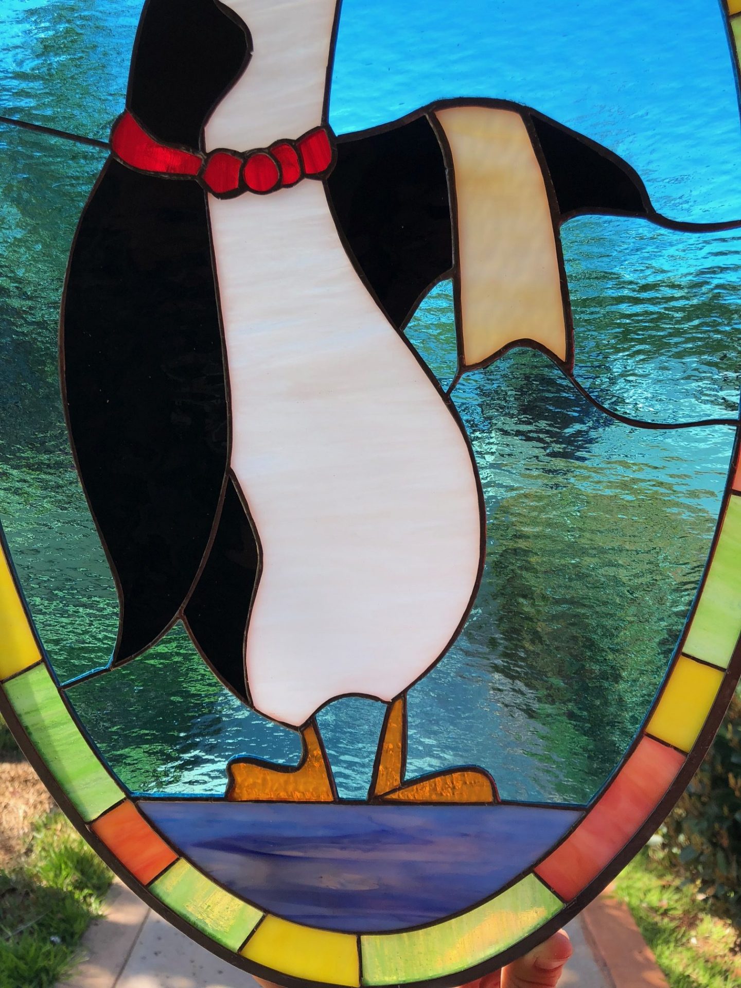 The penguin waiter stained glass window panel