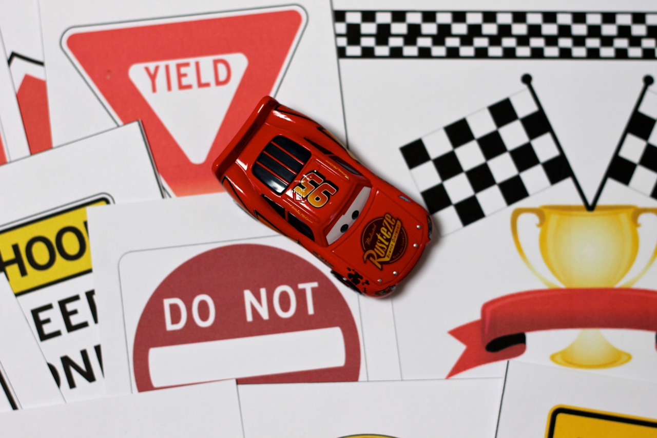 Race car printables with diy checkered flag and race track play mat