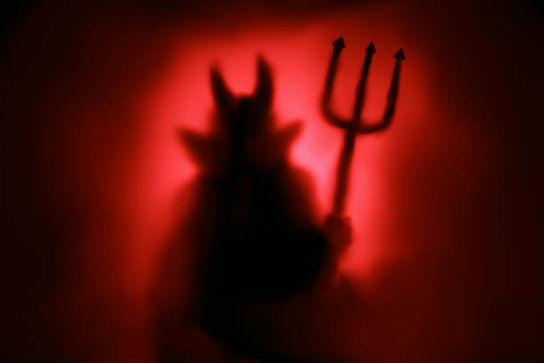 Creepy devil silhouette stock photo