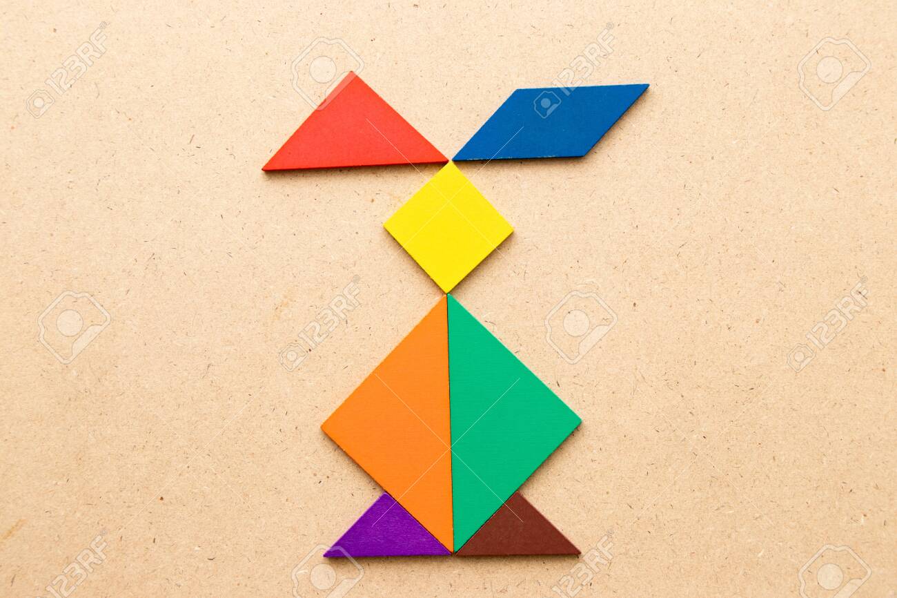 Color tangram puzzle in rabbit shape on wood background stock photo picture and royalty free image image