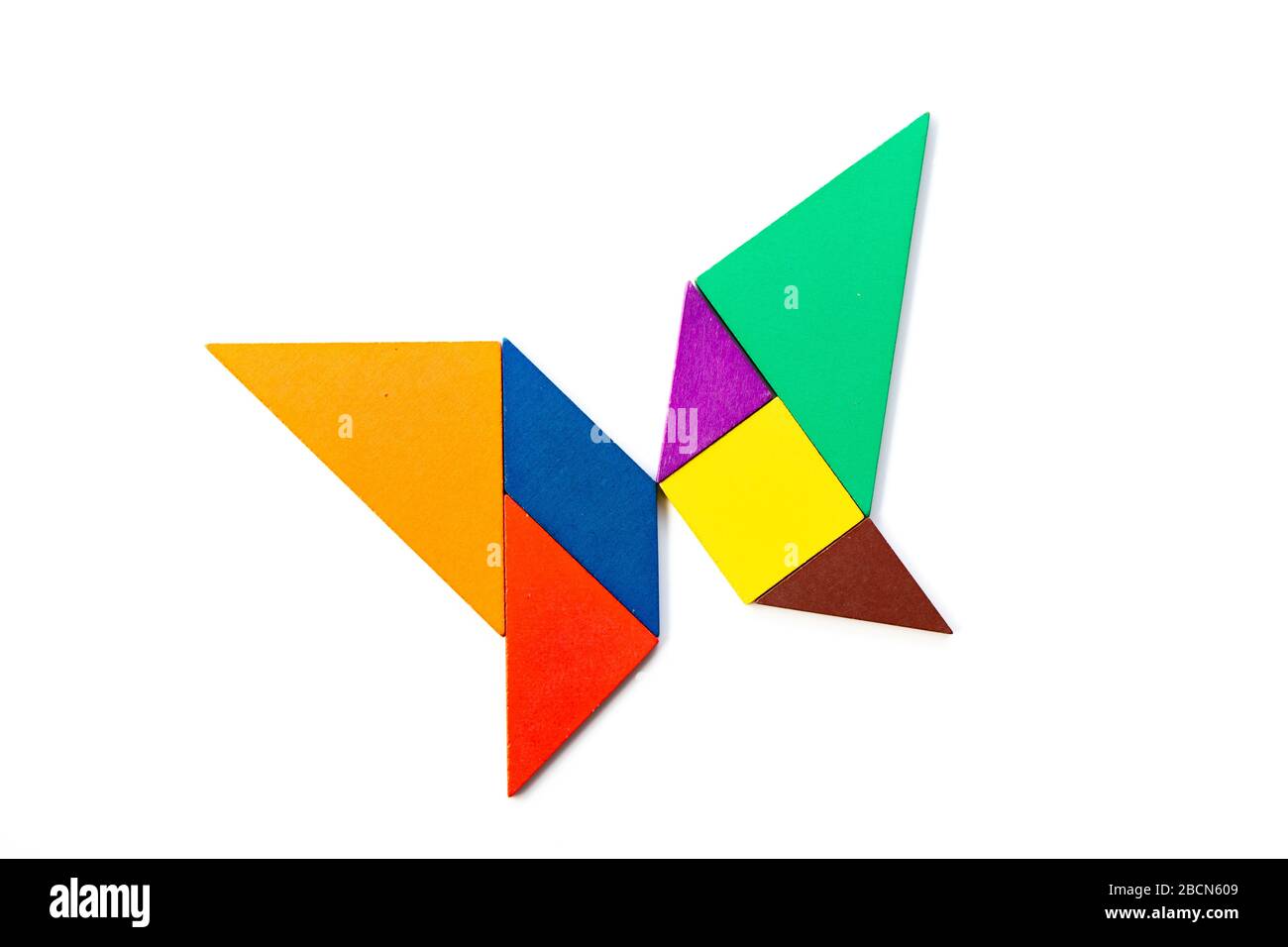 Color wood tangram puzzle in butterfly shape on white background stock photo