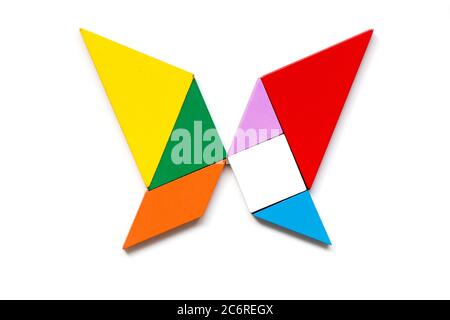 Color wood tangram puzzle in butterfly shape on white background stock photo