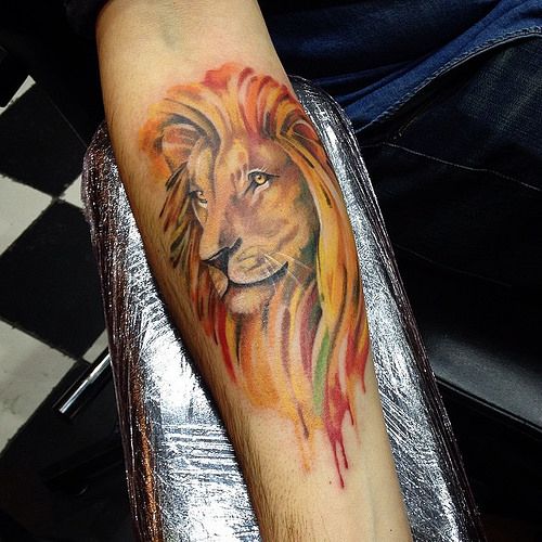 Vibrant watercolor lion tattoo