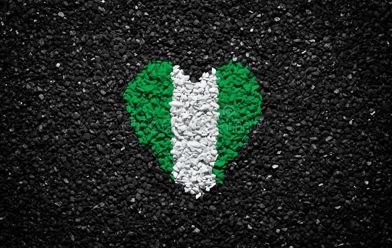 Flag of nigeria nigerian flag heart on the black background stones gravel and shingle wallpaper valentines day stock photo