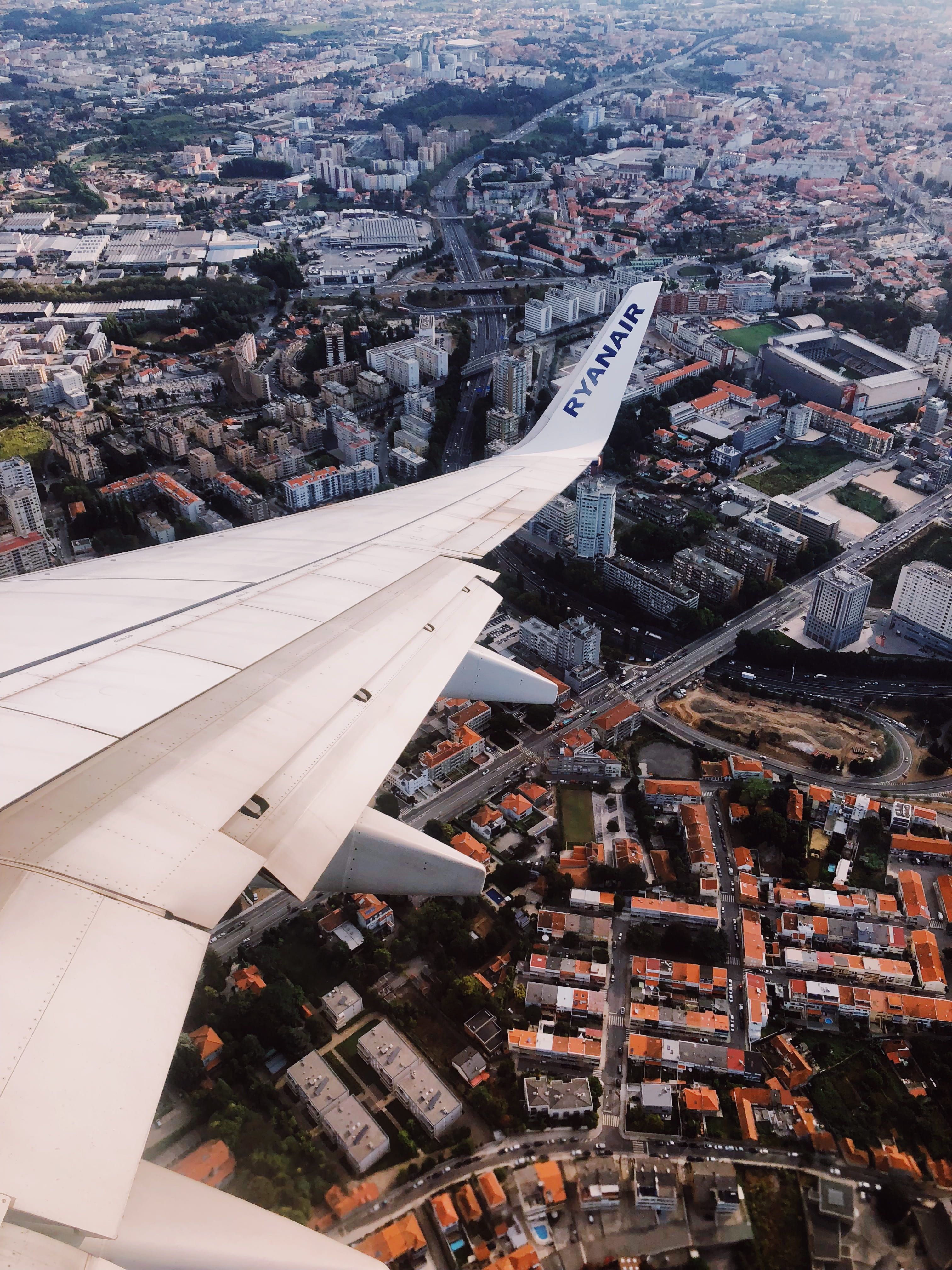 White ryanair plane flying in the sky landscape scenery outdoors aerial view nature city road way urban town building downâ scenery landscape ryanair