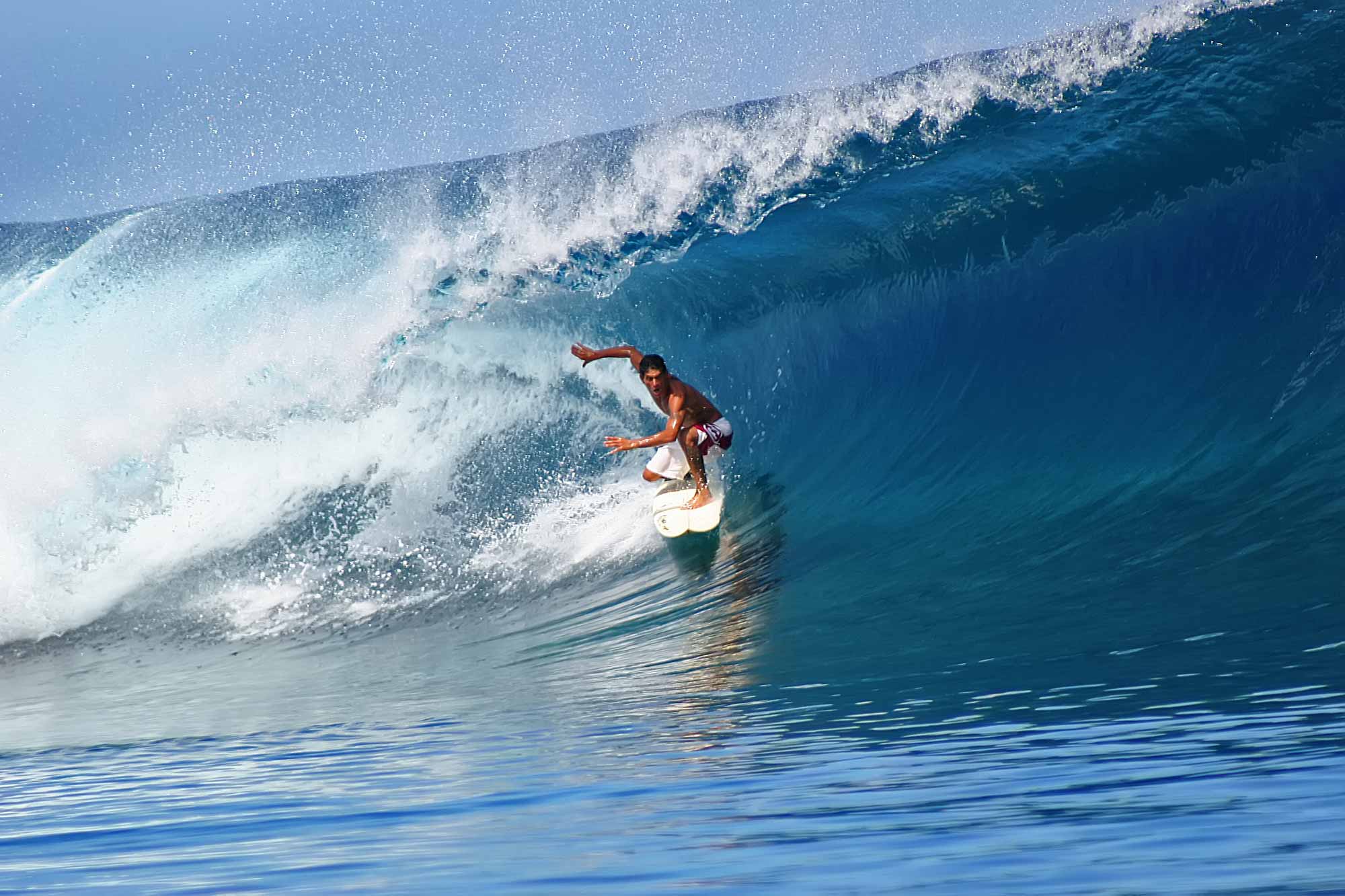 Surfing the waves at teahupoo tahiti travel documentary photography by ulli maier nisa maier