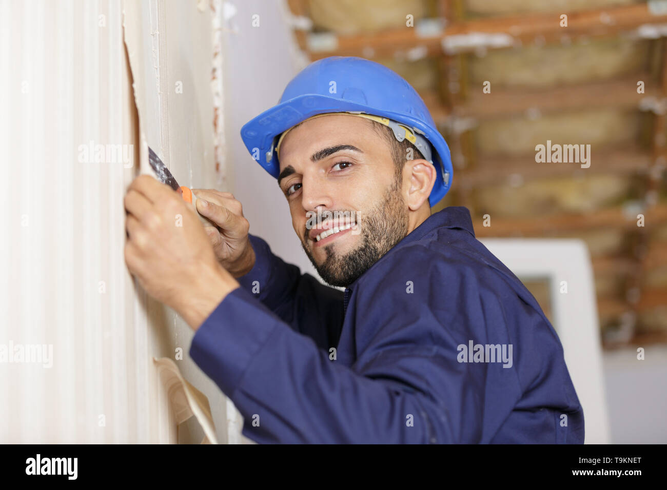 Man stripping wallpaper hi