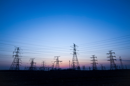 The silhouette of the evening electricity transmission pylon stock photo