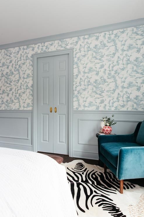 Light gray wainscoting accents white and blue wallpaper lined with light gray crown moldings and a lâ blue accents bedroom wainscoting bedroom wallpaper bedroom