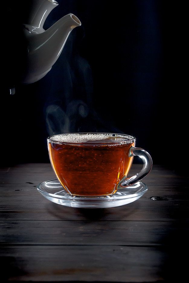 Premium photo cup of tea on black background tea tea cups tea wallpaper