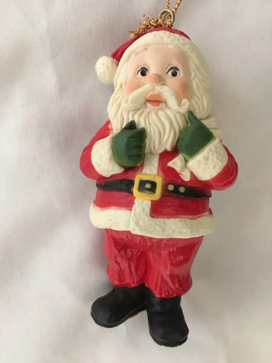 Red white santa wearing green gloves figurine ornament