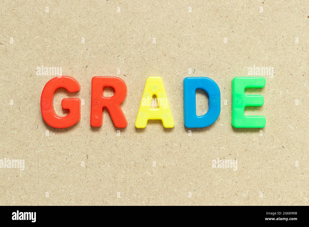 Color alphabet letter with word grade on wood background stock photo