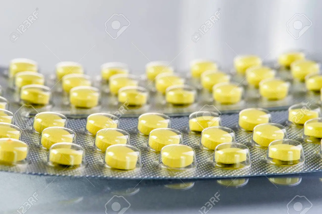 Yellow medicine pills on white background pharmaceutical medicament antibiotic painkiller or narcotic closeup stock photo picture and royalty free image image